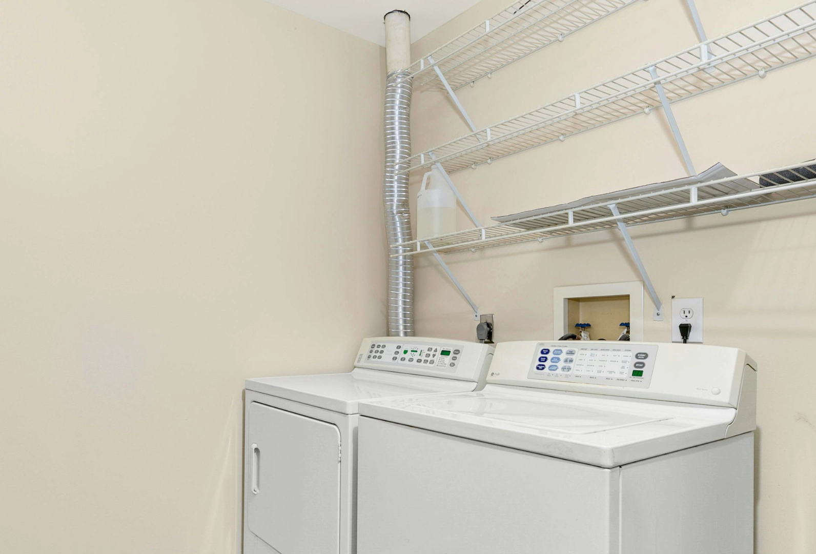 dryer with vent duct behind